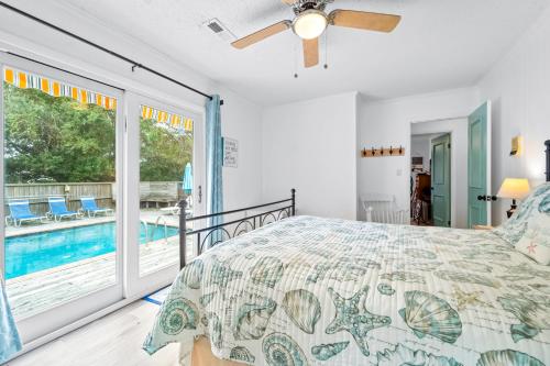 a bedroom with a bed and a balcony with a pool at 4720 Summer Ln in Kitty Hawk