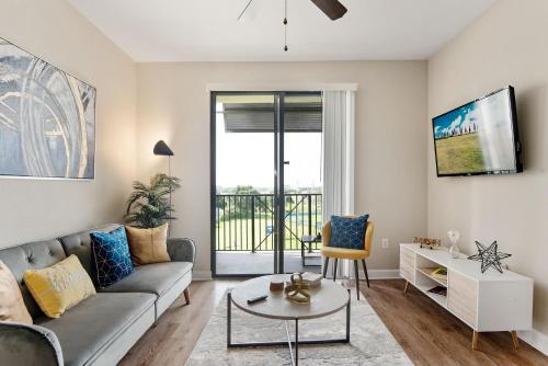 a living room with a couch and a table at Tampa Tropical-10 Min to Airport in Tampa