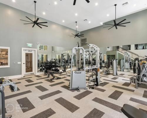 a gym with treadmills and machines in a room at Tampa Tropical-10 Min to Airport in Tampa