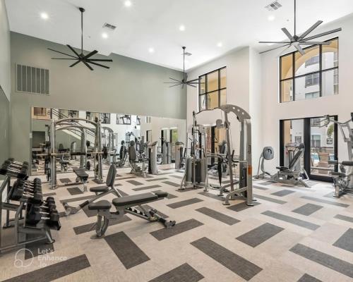 a gym with several treadmills and weights at Tampa Tropical-10 Min to Airport in Tampa
