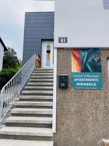 a staircase leading to a building with a sign on it at Apartment Mirabelle 3 in Püttlingen