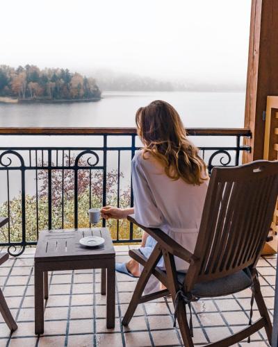 a woman sitting in a chair with a glass of wine at Hotel Quintessence in Mont-Tremblant