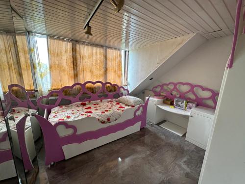 a bedroom with purple and white beds and a window at Wow in Rotterdam