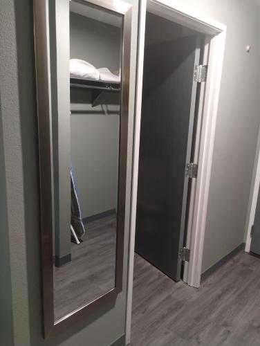 an open door to a closet with a mirror at Quality Inn & Suites Wilsonville in Wilsonville