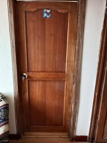a wooden door with a sticker on it at Casa Rural Zaba Lago de Tota in Aquitania