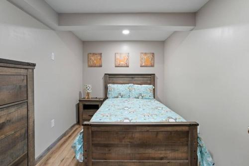 a bedroom with a wooden bed and a wooden dresser at Rustic Luxury in the Pocono Mountains - Stag Lodge in Pocono Lake