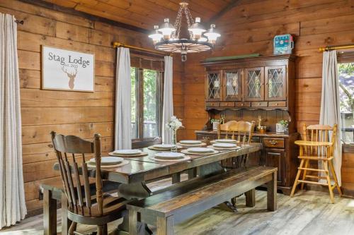 a wooden dining room with a table and chairs at Rustic Luxury in the Pocono Mountains - Stag Lodge in Pocono Lake