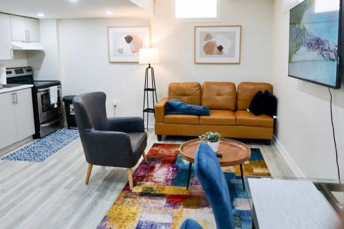a living room with a couch and a table at Garden Ave Suite 3 Mins to Hwy 403 in Brantford
