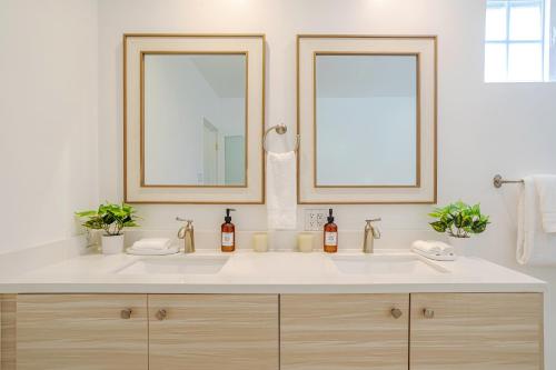 a bathroom with a white sink with two mirrors at Exquisite Oasis near Universal Studios with Large Pool in Los Angeles