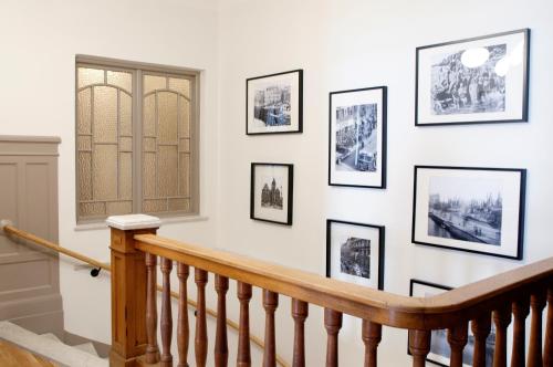 a staircase with framed pictures on a white wall at Continental Apartment Hotel Sundsvall in Sundsvall