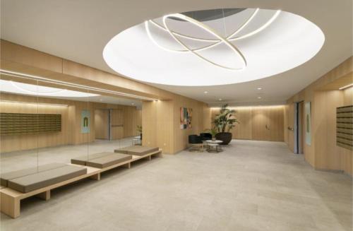 a hospital lobby with benches and a large chandelier at InTempo Luxury Sky View & Spa Resort in Benidorm