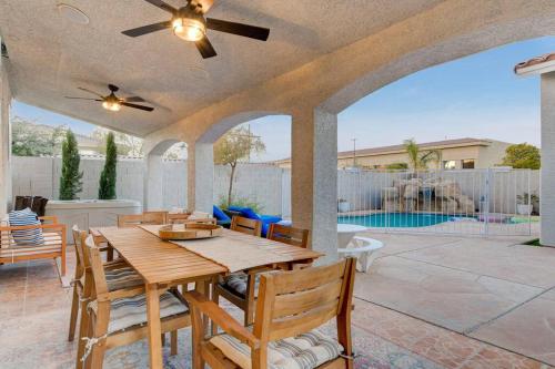 a patio with a table and chairs and a pool at Beautiful 5BR w/King Beds, Pool & Hot Tub, Games in Las Vegas