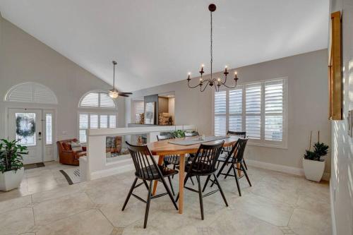 a dining room and kitchen with a table and chairs at Beautiful 5BR w/King Beds, Pool & Hot Tub, Games in Las Vegas