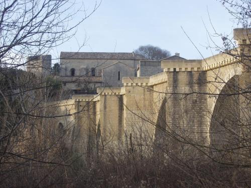 a castle sitting on top of a wall at Location Saisonnière Villa in Uzès