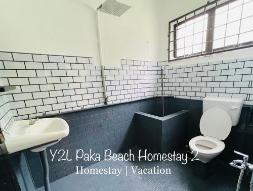 a bathroom with a toilet and a sink at CozyLuxury Homestay Paka 3-7pax near Paka Beach and surrounding many Restaurant - Y2L Homestay 2 in Paka