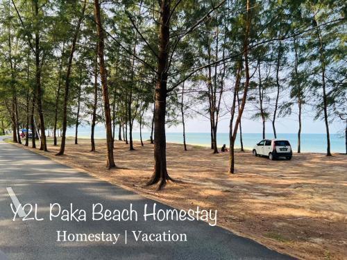a car parked on the side of a beach with trees at CozyLuxury Homestay Paka 3-7pax near Paka Beach and surrounding many Restaurant - Y2L Homestay 2 in Paka