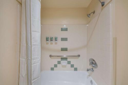 a small bathroom with a shower and a toilet at Best Western Salinas Valley Inn & Suites in Salinas