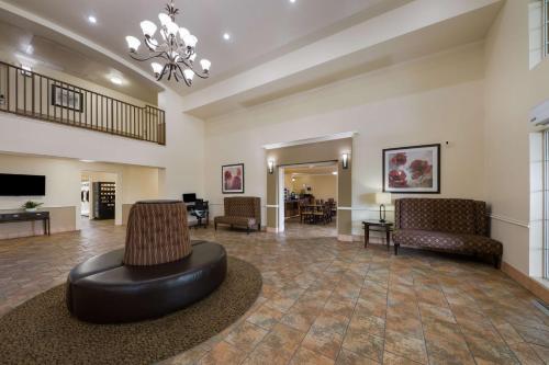 a lobby with a couch and chairs and a television at Best Western Salinas Valley Inn & Suites in Salinas