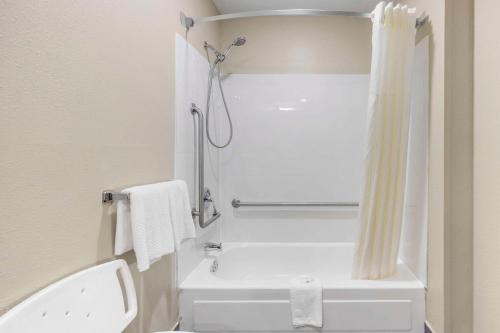 a bathroom with a shower and a white toilet at Quality Inn in Jackson