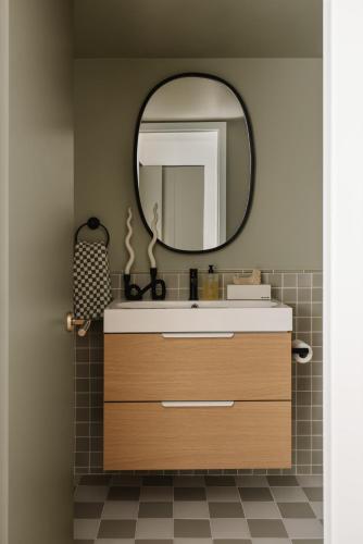 a bathroom with a sink and a mirror at Ski-in/Ski-out Intentionally Designed Ski Lodge in Whistler