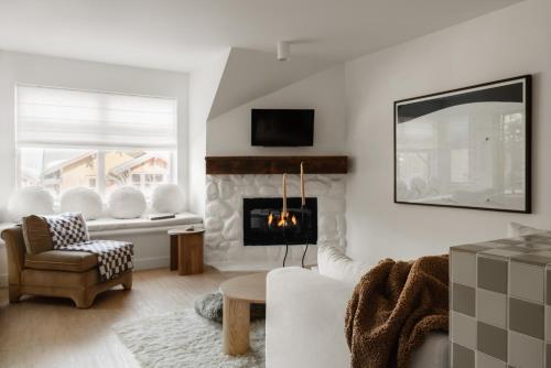 een woonkamer met een bank en een open haard bij Ski-in/Ski-out Intentionally Designed Ski Lodge in Whistler