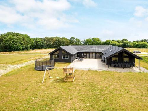 a house with a playground in the middle of a field at Luxury Beach Retreat - By Traum Ferienwohnungen in Sarup