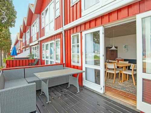 a patio with a table and chairs on a building at 4 star holiday home in Ebeltoft-By Traum in Ebeltoft
