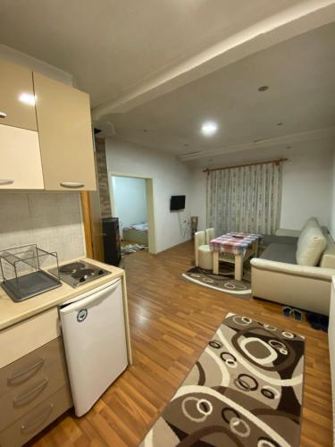 a kitchen and a living room with a stove and a couch at Vila Ivan in Berovo