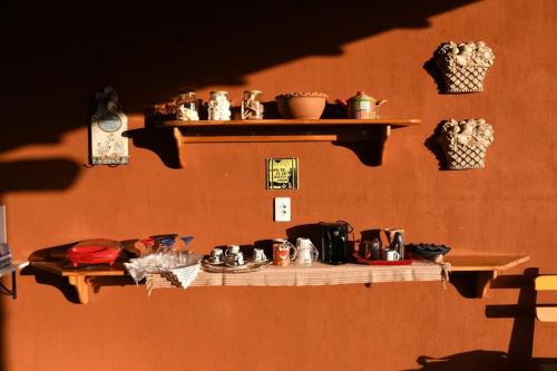 a shelf on a wall with items on it at Chalés Aconchego in Pirenópolis