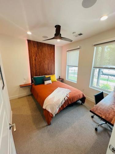 a bedroom with a bed and a ceiling fan at Downtown Denver Smart House in Denver