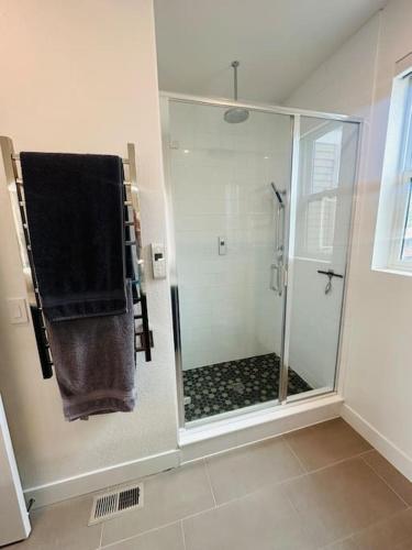 a bathroom with a shower with a glass door at Downtown Denver Smart House in Denver