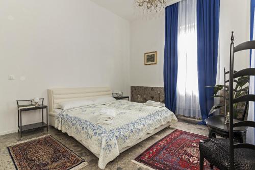 a white bedroom with a bed and a window at E&E Apartments in Ljubljana