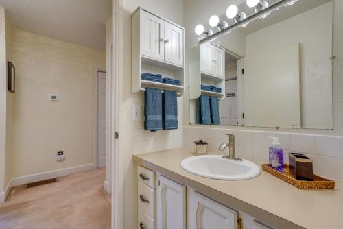 a bathroom with a sink and a mirror at Charming Anchorage Home with Private Hot Tub! in Anchorage