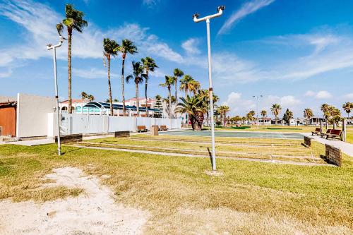 a park with palm trees and a tennis court at Long Island Village 502 Clam in Port Isabel