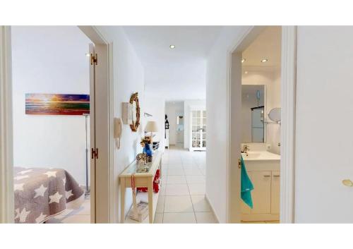 a white kitchen with a sink and a counter at Perchel Sport in Las Palmas de Gran Canaria