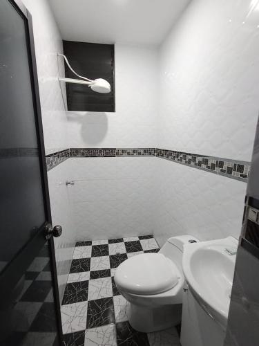 a bathroom with a toilet and a sink at O'cala House 2.0 in Huánuco