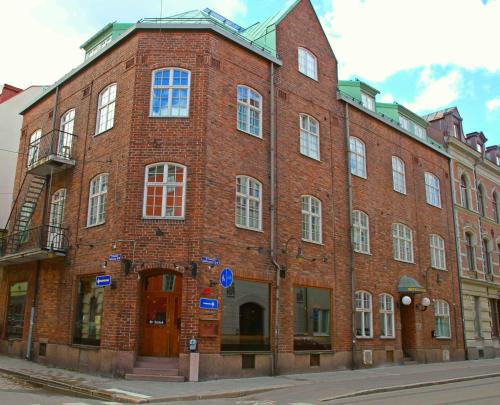 a large brick building on the corner of a street at Continental Apartment Hotel Sundsvall in Sundsvall