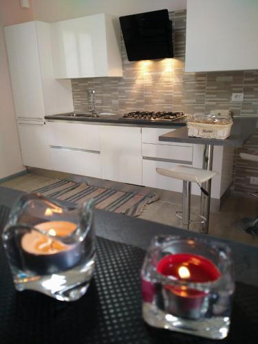 a kitchen with a table with candles and a counter top at Appartamenti Centro Seriate in Seriate