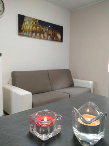 two candles sitting on a table in a living room at Appartamenti Centro Seriate in Seriate