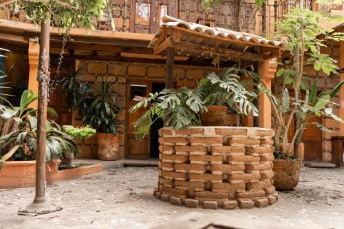 a building with a stack of bricks and plants at Hotel CasaMia in Dolores Hidalgo