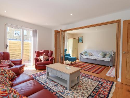 a living room with a couch and a table at Wellington Cottage in Ely