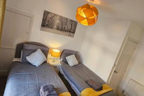 a bedroom with two beds and a basketball hanging from the wall at Alfred House in Ripley