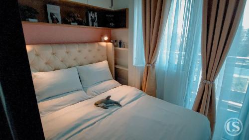 a small bird sitting on a bed in a room at Crissome Suite Azure North San Fernando Pampanga in Lagundi