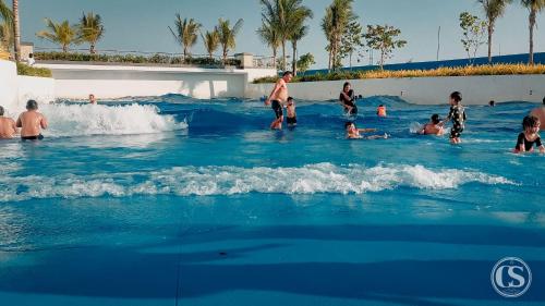 a group of people in the water at a swimming pool at Crissome Suite Azure North San Fernando Pampanga in Lagundi