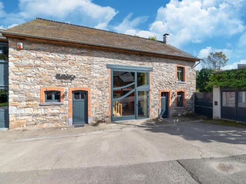 a stone building with a large door on it at Holiday home situated in a rural setting in Lierneux