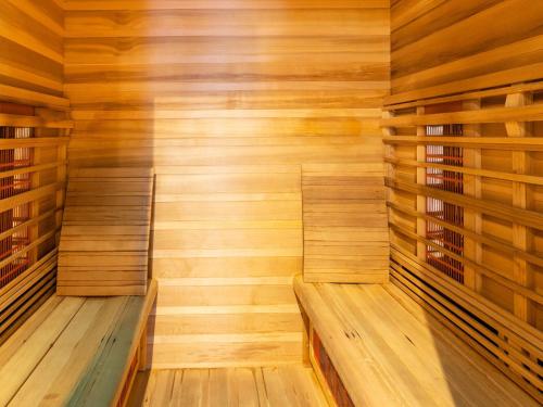 a wooden sauna with a bench in the middle at Holiday home situated in a rural setting in Lierneux