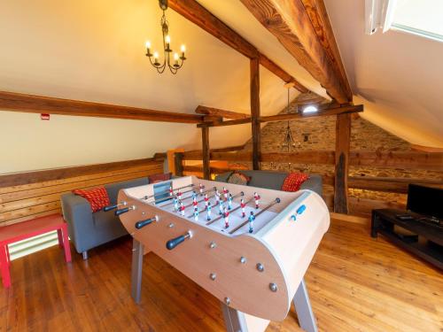 a living room with a foosball table in a room at Holiday home situated in a rural setting in Lierneux
