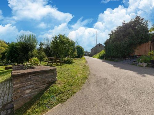 a dirt road with a fence and a picnic table at Holiday home situated in a rural setting in Lierneux