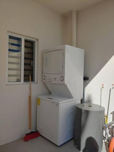 a computer monitor sitting on top of a refrigerator at Casa 337 -New home with garage & community pool in Puerto Peñasco