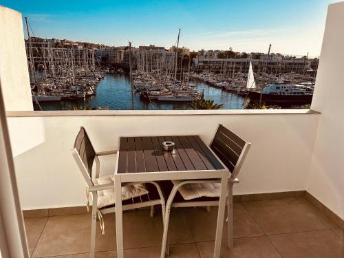 a table and chairs on a balcony with a harbor at Lagos Marina View studio apartment on main avenue in Lagos
